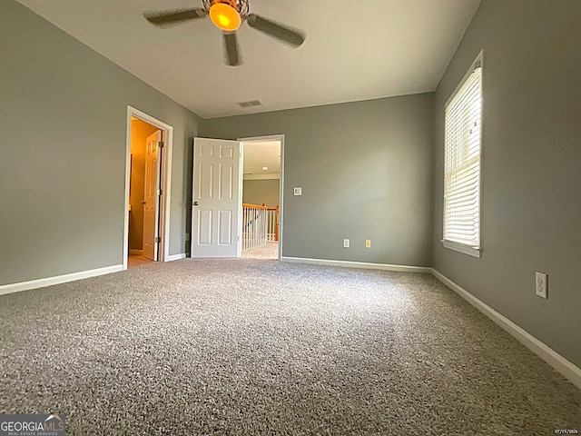 interior space with ceiling fan and carpet flooring