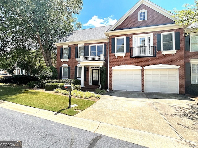 view of front of house with a balcony, a front yard, and a garage