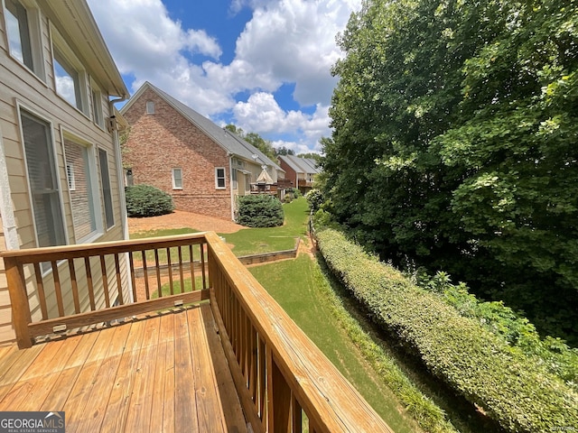 wooden terrace with a lawn