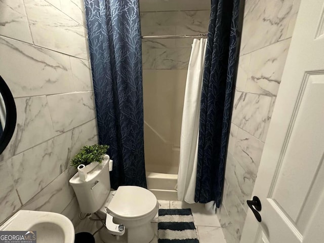 bathroom featuring toilet, shower / tub combo, tile patterned flooring, and tile walls