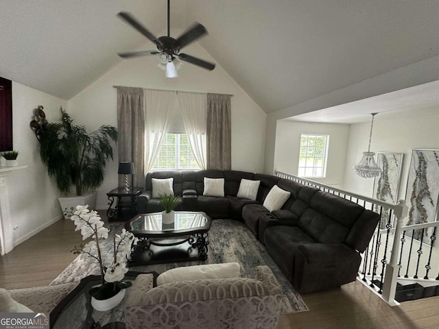 living room with ceiling fan, hardwood / wood-style floors, a healthy amount of sunlight, and lofted ceiling