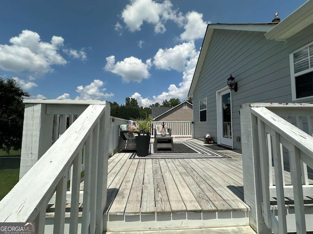 wooden deck featuring outdoor lounge area