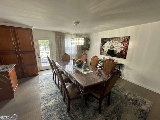 dining room featuring a notable chandelier and light hardwood / wood-style flooring