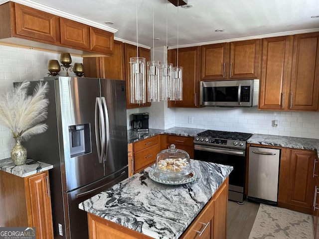 kitchen featuring tasteful backsplash, appliances with stainless steel finishes, light hardwood / wood-style floors, and a kitchen island