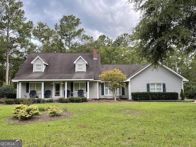 cape cod house with a porch and a front lawn