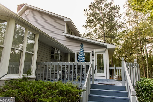 view of exterior entry with a wooden deck