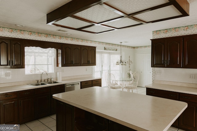 kitchen featuring decorative light fixtures, dishwasher, sink, and dark brown cabinets