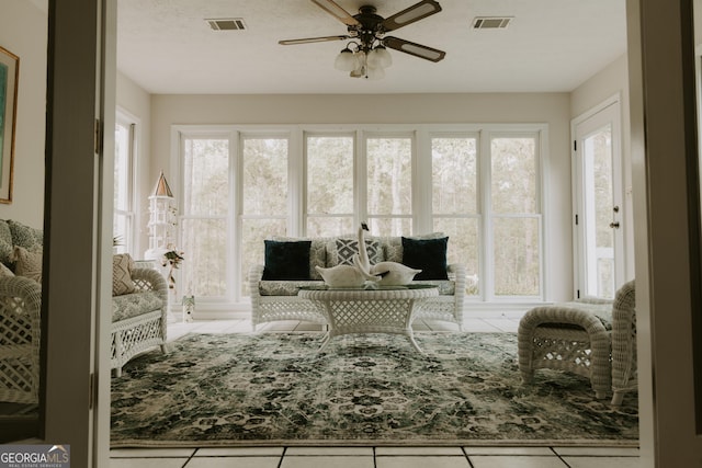 interior space with light tile patterned flooring and ceiling fan