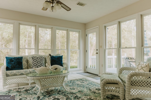 sunroom / solarium featuring plenty of natural light and ceiling fan