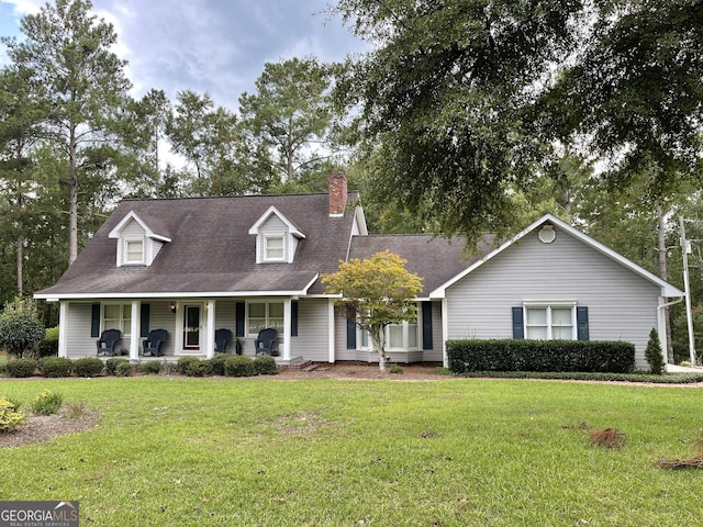 cape cod home featuring a porch and a front yard