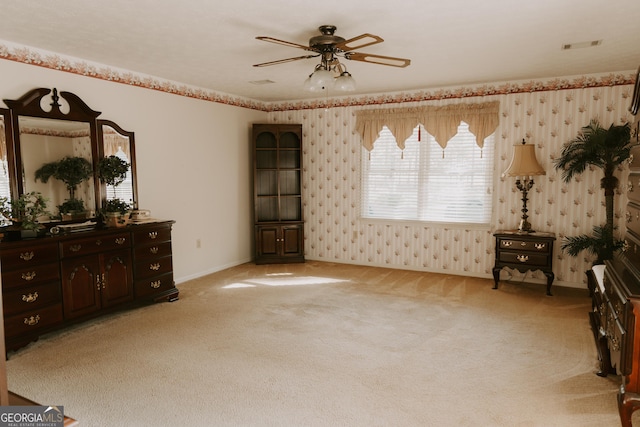 living area with light colored carpet and ceiling fan