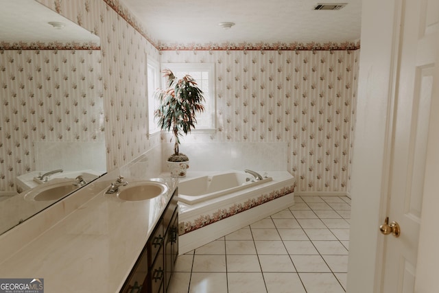 bathroom featuring vanity, a bath, and tile patterned flooring