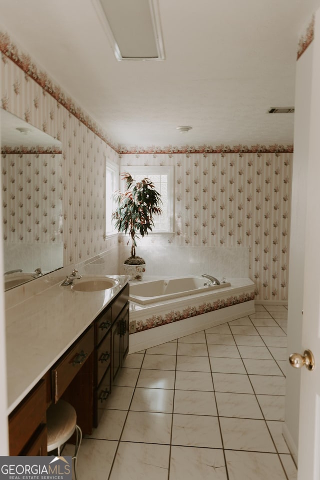 bathroom with vanity, tiled tub, and tile patterned floors