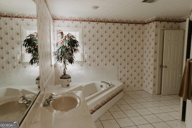 bathroom with vanity, tiled bath, and tile patterned flooring