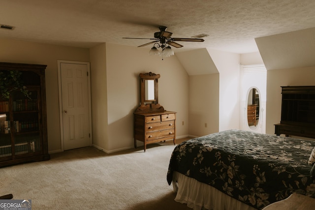 bedroom with ceiling fan, lofted ceiling, light carpet, and a textured ceiling