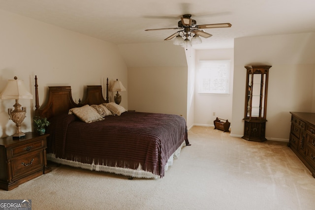 bedroom with ceiling fan, lofted ceiling, and light carpet