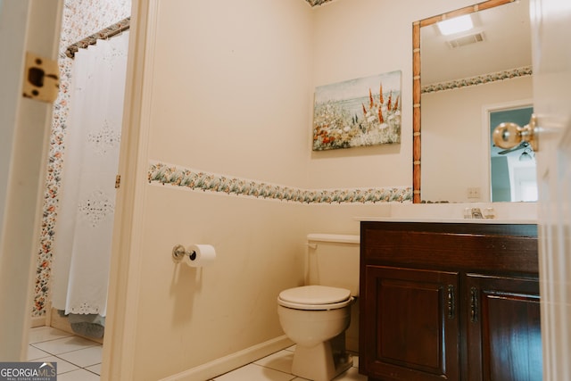 bathroom with vanity, tile patterned floors, and toilet