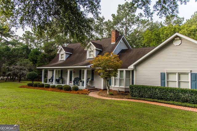 new england style home with a porch and a front yard