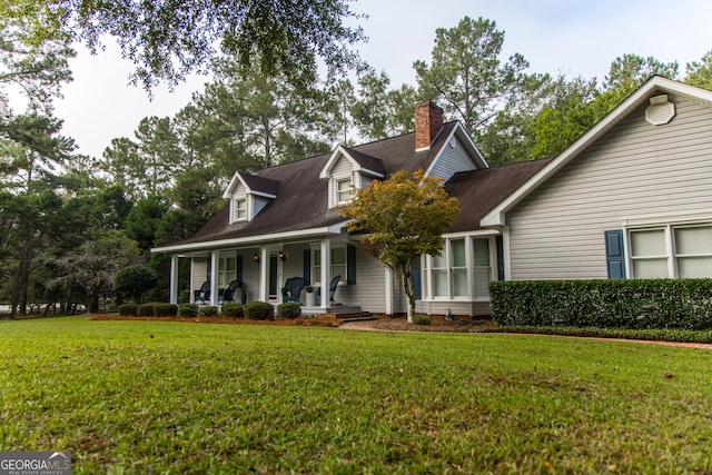 cape cod-style house with a front yard and covered porch