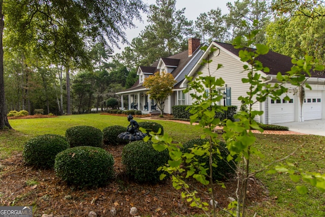 view of front of house featuring a garage and a front lawn