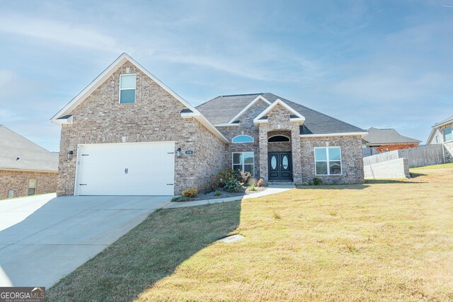 view of front of property with a garage and a front yard