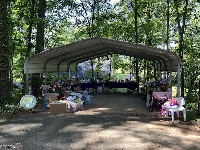 view of parking / parking lot featuring a carport