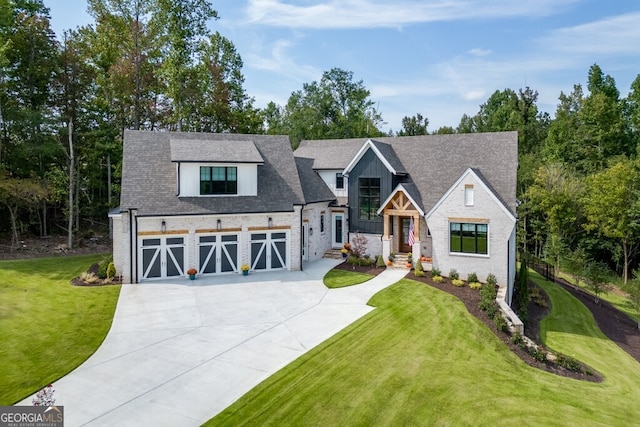 view of front of house featuring a garage and a front lawn