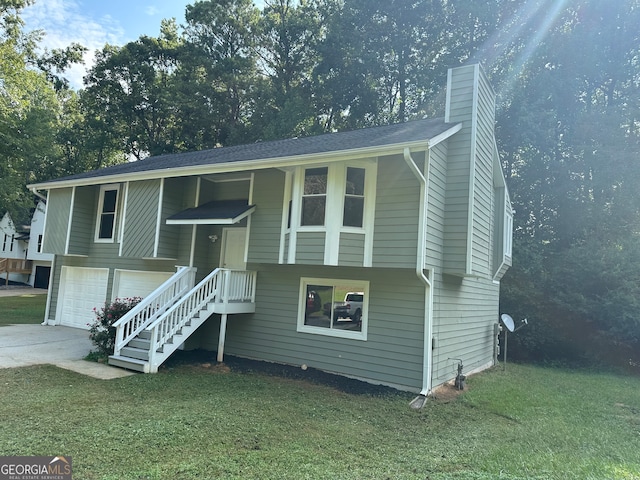 split foyer home with a front yard and a garage