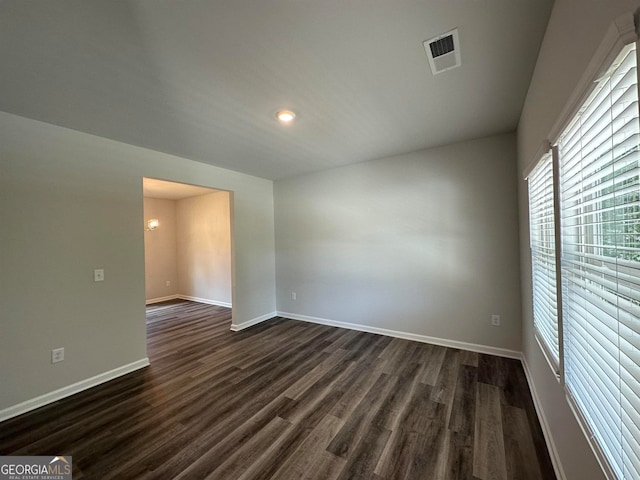 empty room with dark wood-type flooring