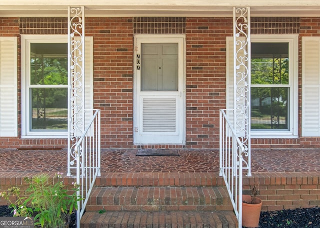 view of exterior entry with a porch