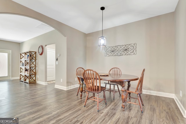 dining space with hardwood / wood-style flooring