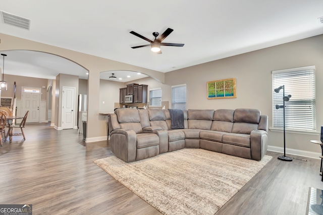 living room featuring ceiling fan and hardwood / wood-style flooring