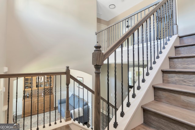 staircase with hardwood / wood-style floors