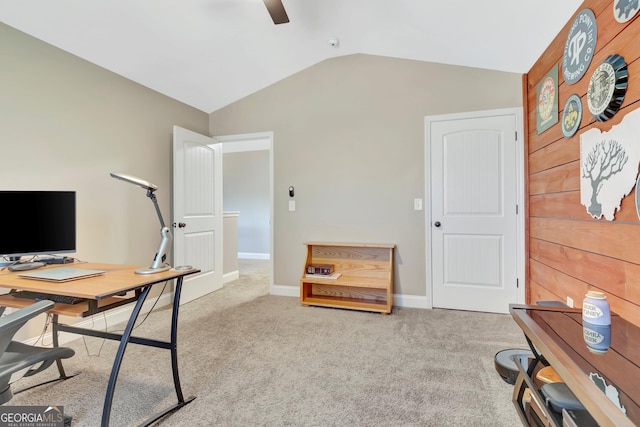 carpeted office featuring lofted ceiling, ceiling fan, and baseboards