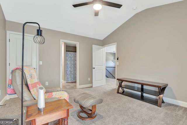 sitting room featuring ceiling fan, light carpet, and vaulted ceiling