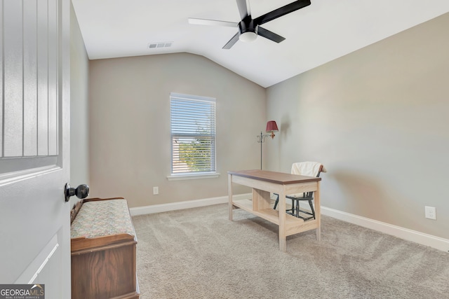 office featuring ceiling fan, light carpet, and lofted ceiling