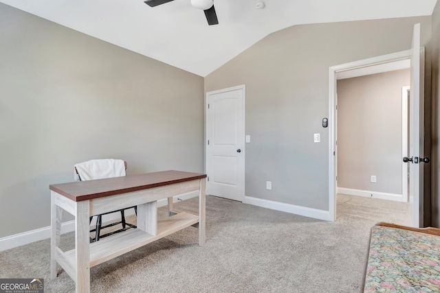 office area with a ceiling fan, lofted ceiling, light carpet, and baseboards