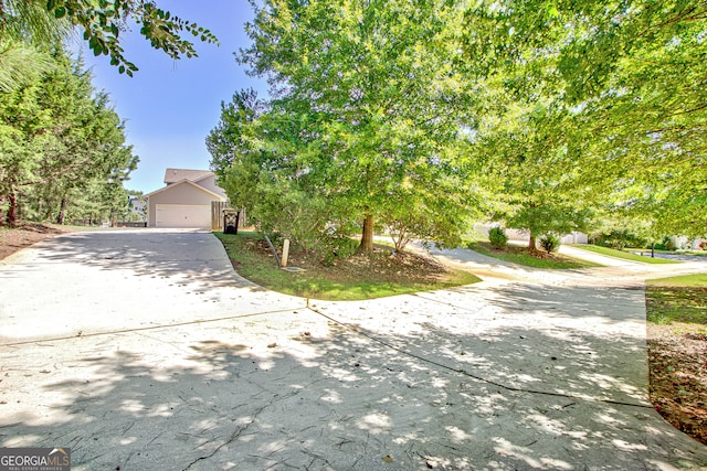 obstructed view of property with a garage