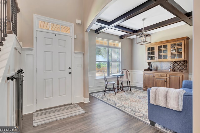 foyer with beam ceiling, coffered ceiling, and wood-type flooring