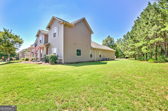 view of side of home with a lawn