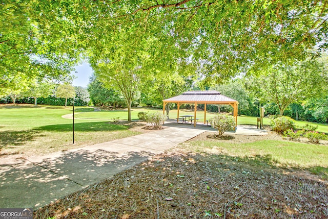 surrounding community with a gazebo and a yard