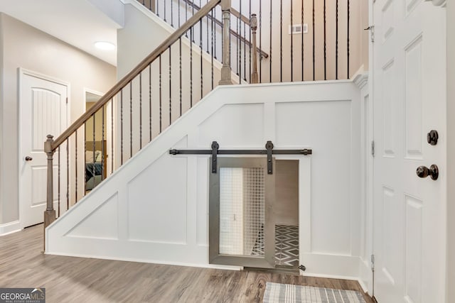 interior space featuring a barn door and hardwood / wood-style floors