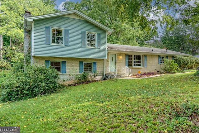 split level home featuring a front lawn