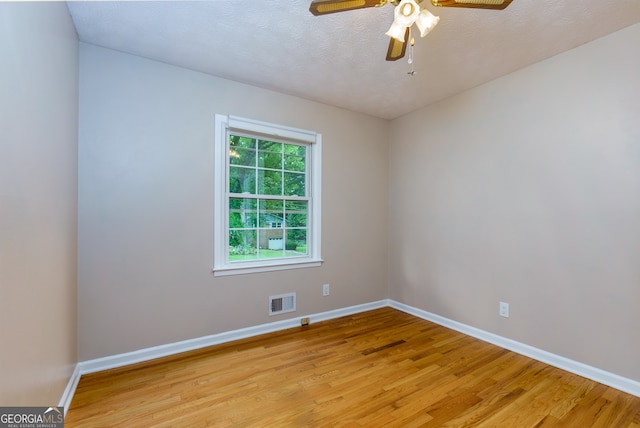 unfurnished room with light hardwood / wood-style flooring, a textured ceiling, and ceiling fan