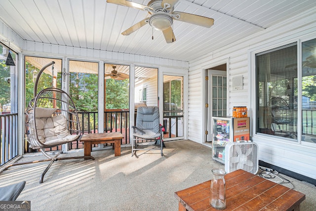 sunroom / solarium with ceiling fan and wooden ceiling