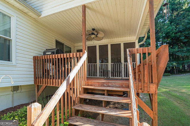 exterior space with ceiling fan and a yard