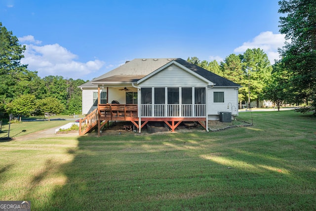 back of property featuring a deck, central AC, and a lawn