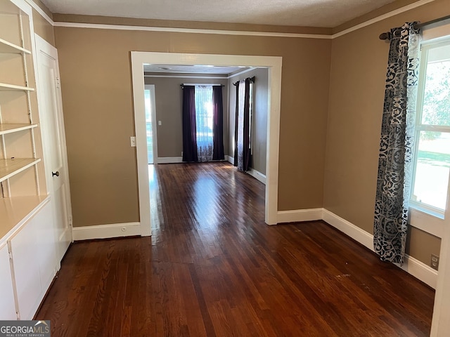 hall featuring a textured ceiling, crown molding, and dark hardwood / wood-style flooring