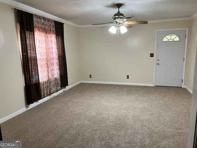 entryway featuring ceiling fan, carpet floors, and ornamental molding