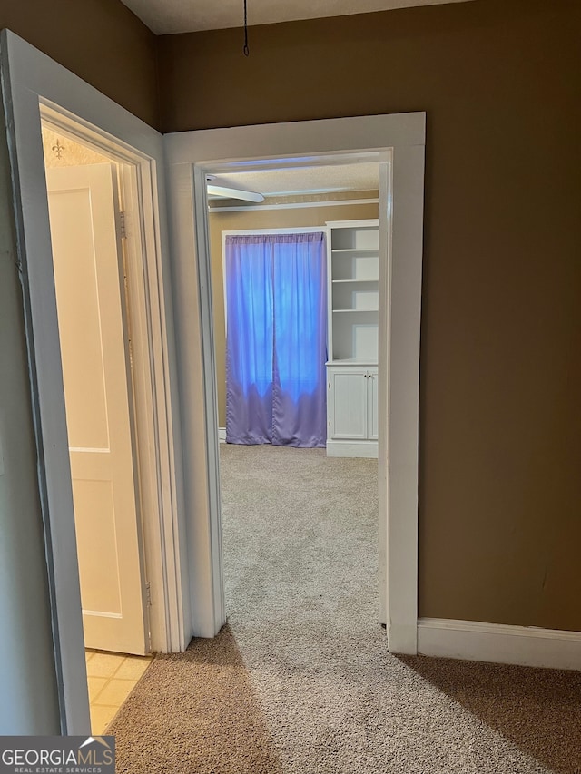 hallway with light colored carpet